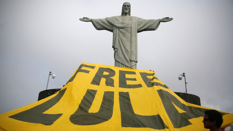 Supporters of former Brazilian President Luiz Inacio Lula da Silva display a banner in front of the statue of Christ the Redeemer in Rio de Janeiro, Brazil, on April 14, 2018. Supporters of former Brazilian President Luiz Inacio Lula da Silva display a banner in front of the statue of Christ the Redeemer in Rio de Janeiro